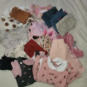 Lot of girls' clothing for 12-month-olds, with a variety of items.